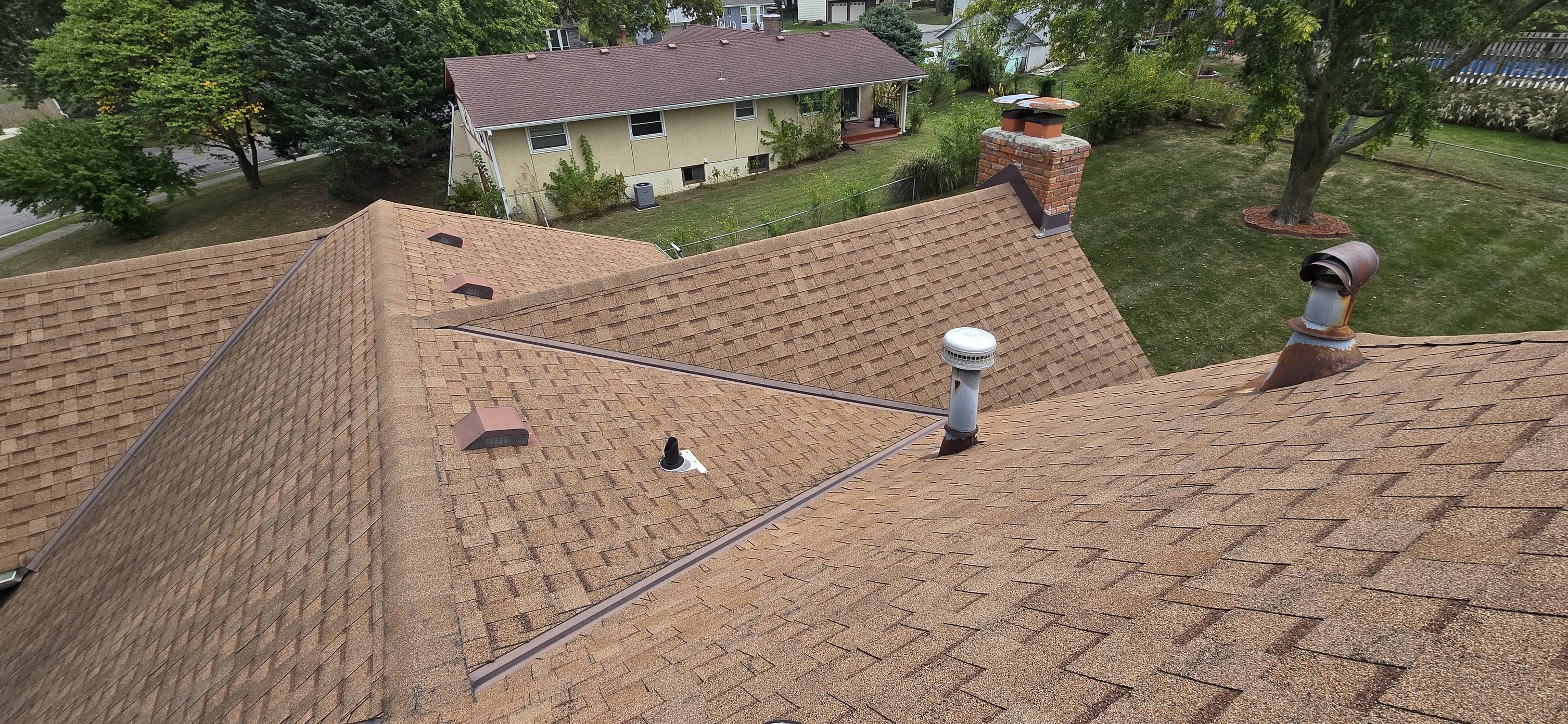 Asphalt shingle roof replacement and ventilation improvements by Brown Roofing LLC.